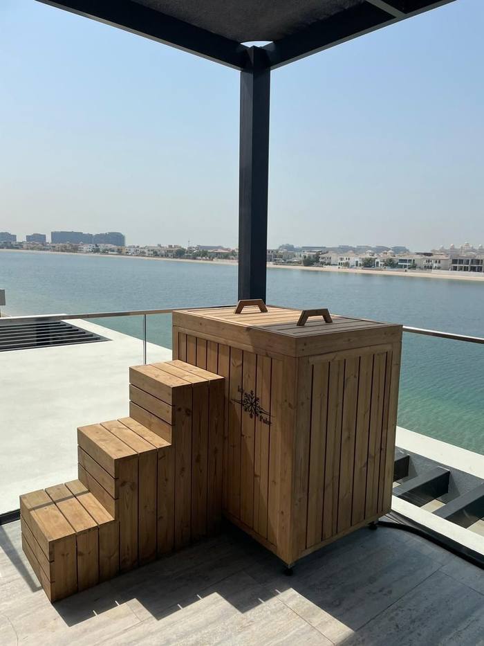 Wooden barrel-style cold plunge overlooking the water, Dubai