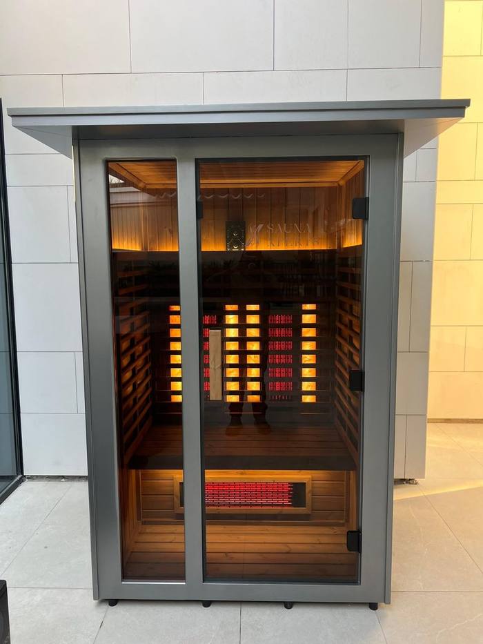 SaunaXperts infrared sauna cabin with etched logo glass door