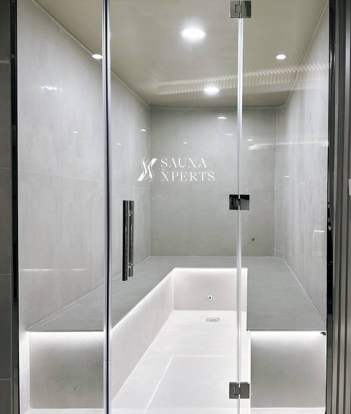 SaunaXperts glass steam room installation with etched logo
