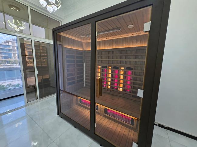 Indoor infrared sauna with full-spectrum heating panels, marble floor villa interior