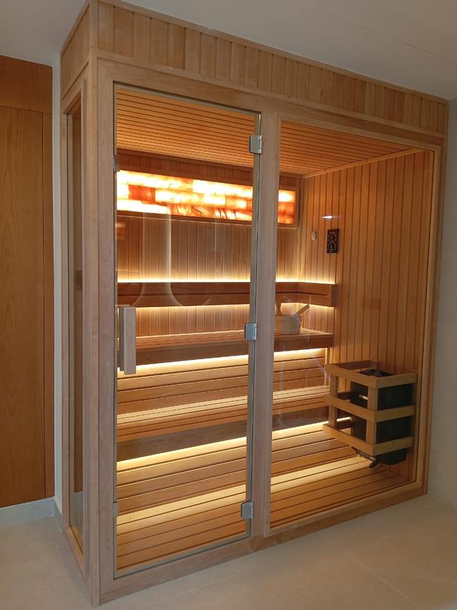 Indoor sauna with Himalayan salt wall accent and traditional heater, Dubai villa
