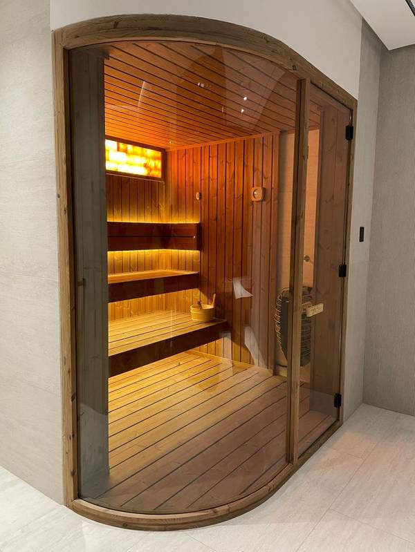 SaunaXperts Home 8 Custom curved sauna nook with Himalayan salt wall built into a home wall alcove