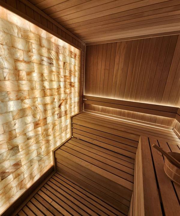 SaunaXperts Home 9 Curved sauna interior with salt wall and timber benching, alternate angle
