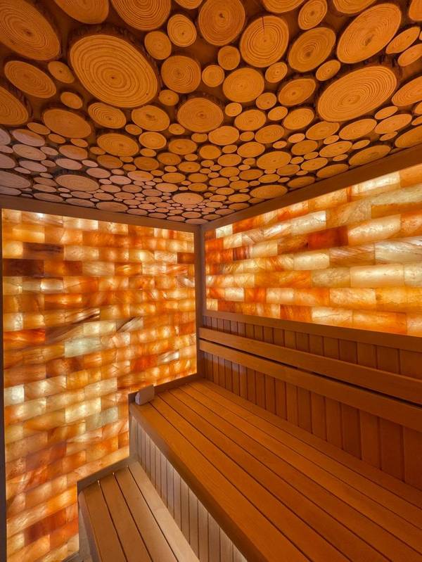 SaunaXperts Home 16 Custom circular wood log-slice ceiling design above a Himalayan salt wall sauna