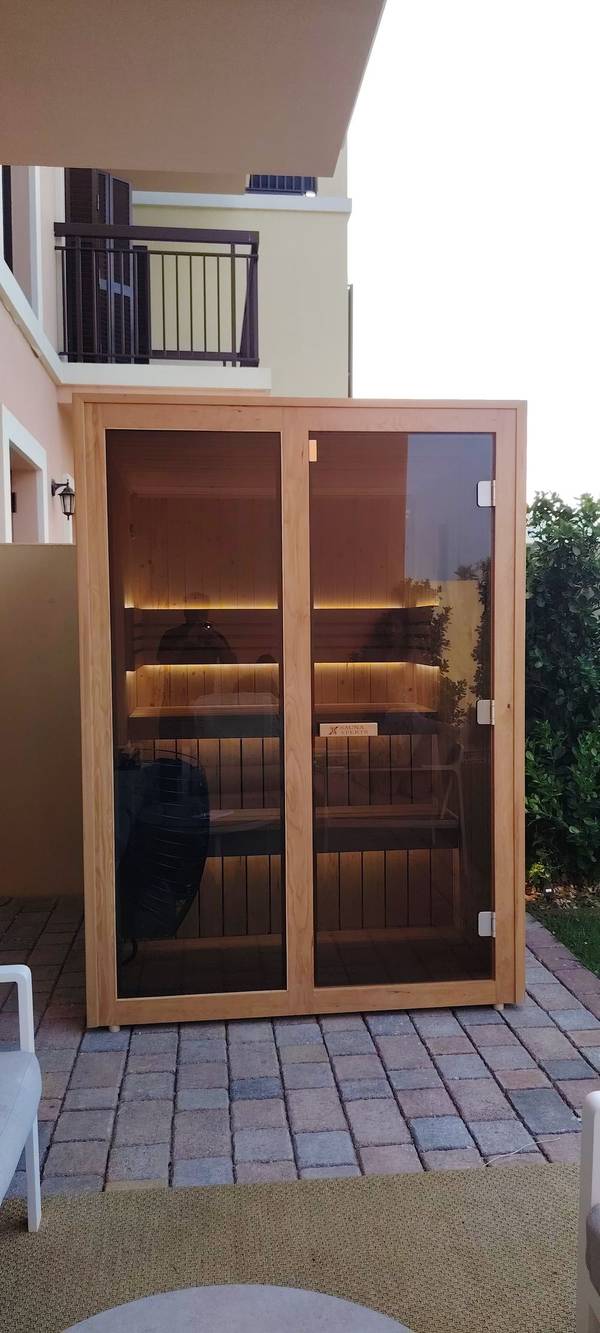 SaunaXperts Home 11 Outdoor sauna cabin installation at dusk in a UAE residential community